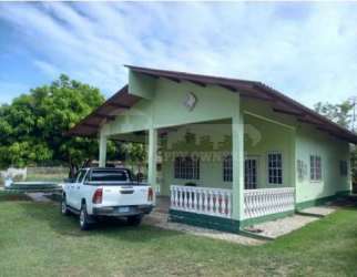 Front porch of single-story beach house with parking and trees in Nueva Gorgona Panama