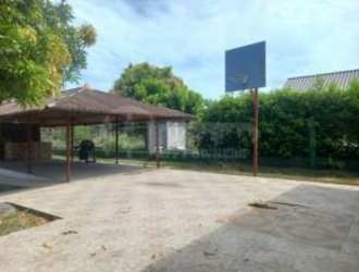 Decorative fountain structure surrounded by lawn in Nueva Gorgona beach property