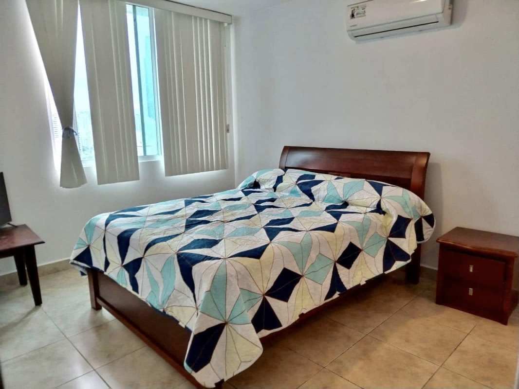 Spacious bedroom with built-in closet, tiled flooring, AC and large window overlooking city in PH El Cangrejo Central Panama City