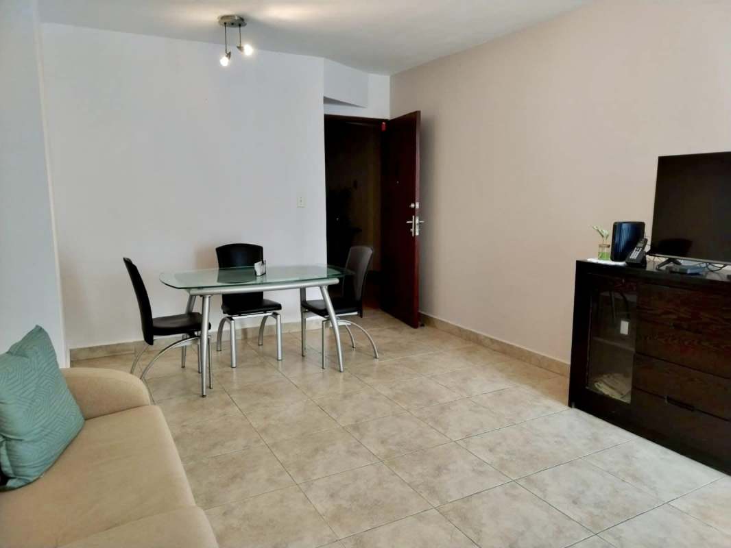 Contemporary kitchen with integrated laundry, gas stove, tile floor, and appliances in PH El Cangrejo Central Panama City