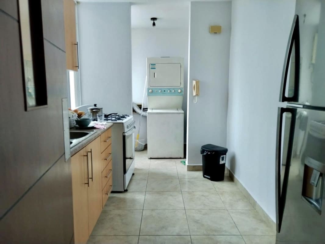 Kitchen fitted with gas stove, refrigerator, washer and contemporary cabinets in PH El Cangrejo Central Panama City