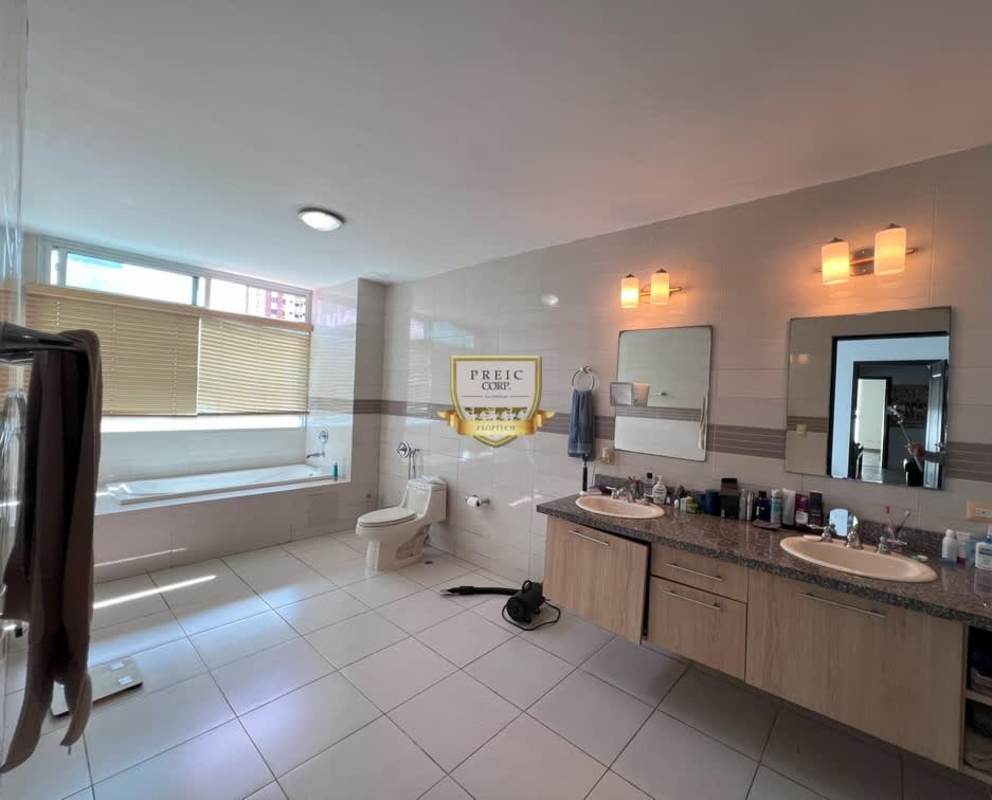 Modern bedroom with large windows overlooking city in PH Titanium Tower Panama