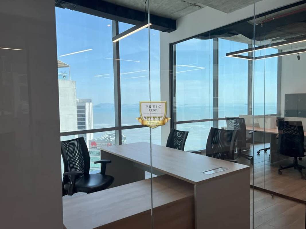 Interior commercial office with glass partition, open workspace, and natural light Panama City