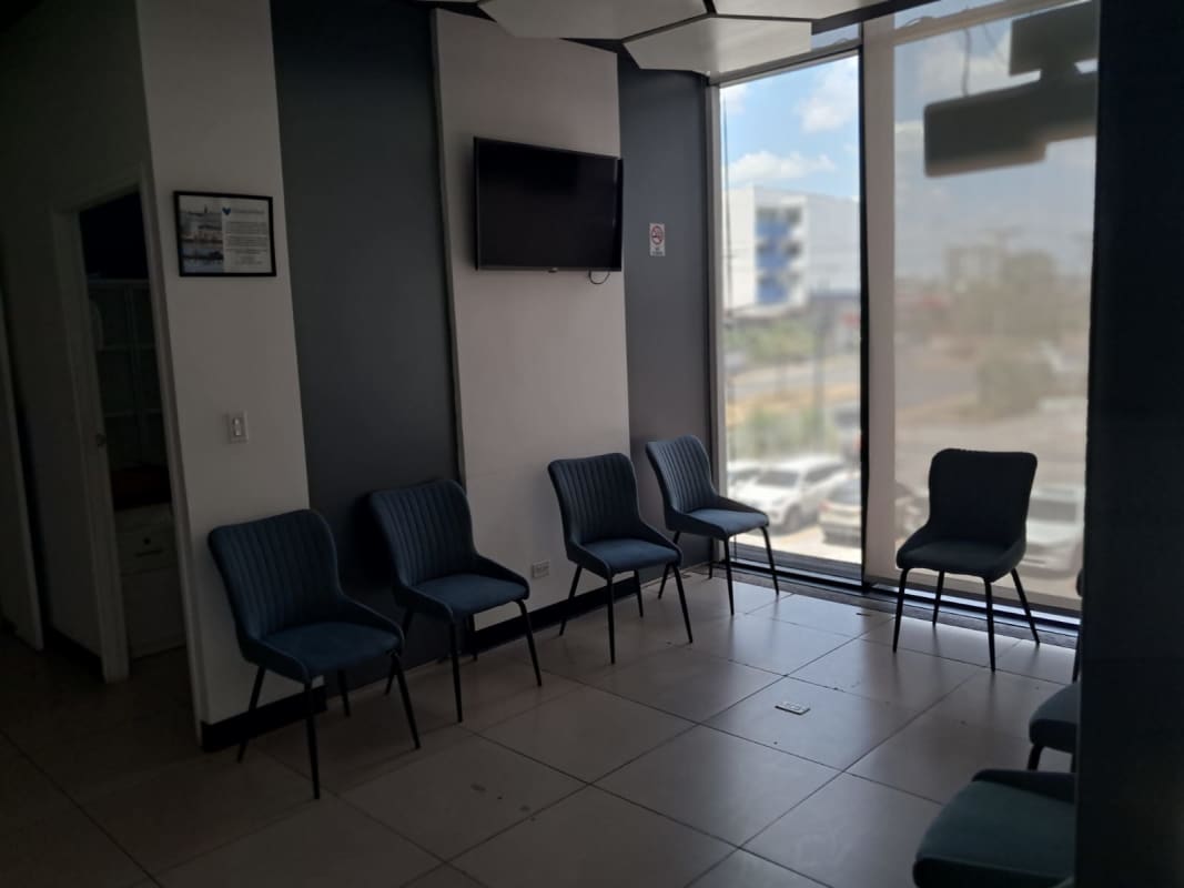 Client waiting room with blue chairs, TV large windows in commercial space Plaza Liberty Panama
