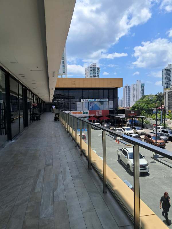 Shopping plaza open walkway with parking lot and skyline view Plaza Liberty 12 de Octubre Panama