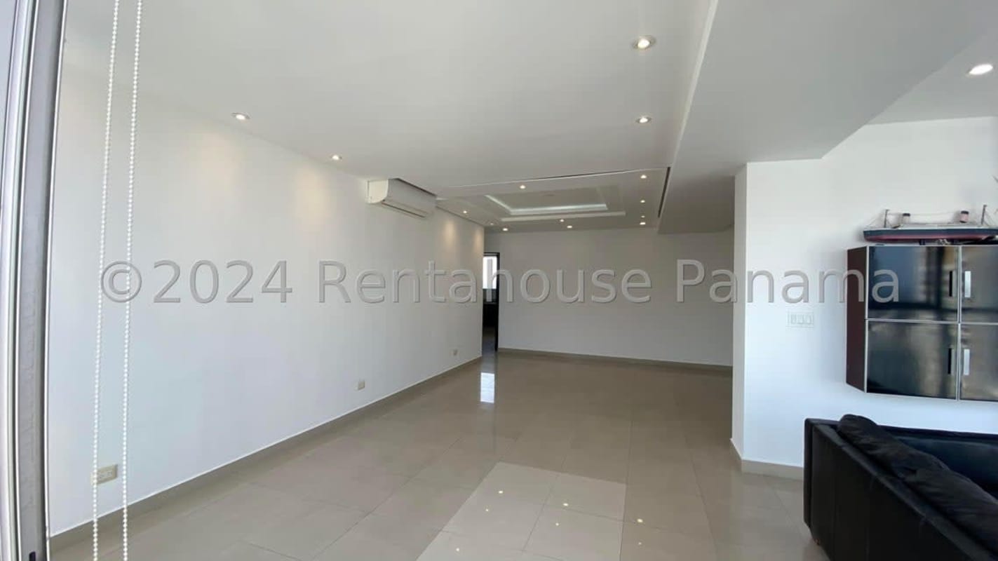 Open living and dining room area with large windows overlooking city Panama City PH Mediterráneo