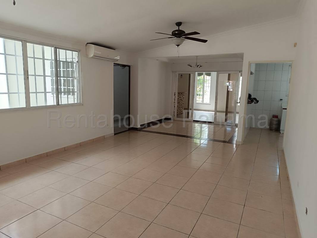 Large living area with tiled floors, ceiling fans, bright windows in house for sale in Brisas del Golf Panama