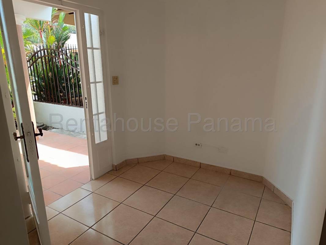 Bright kitchen with tile walls, cabinets, and stainless sink in Brisas del Golf Panama house for sale