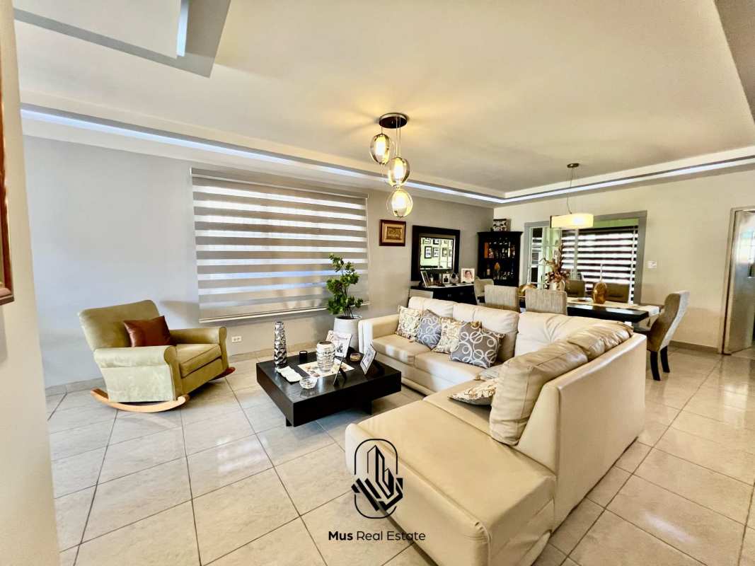 Modern open plan living dining with sectional sofa, large windows and tiled floors in Brisas del Golf Panama