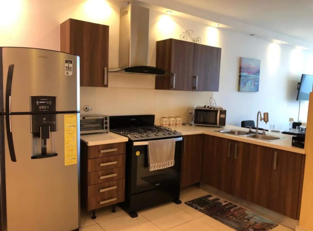 Modern kitchen with granite counters, stainless appliances in oceanview Punta Pacifica apartment Panama