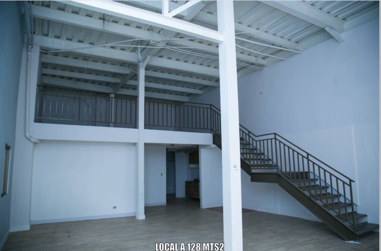 Industrial style commercial unit featuring mezzanine, exposed ceiling beams, and metal stairs in San Francisco Panama