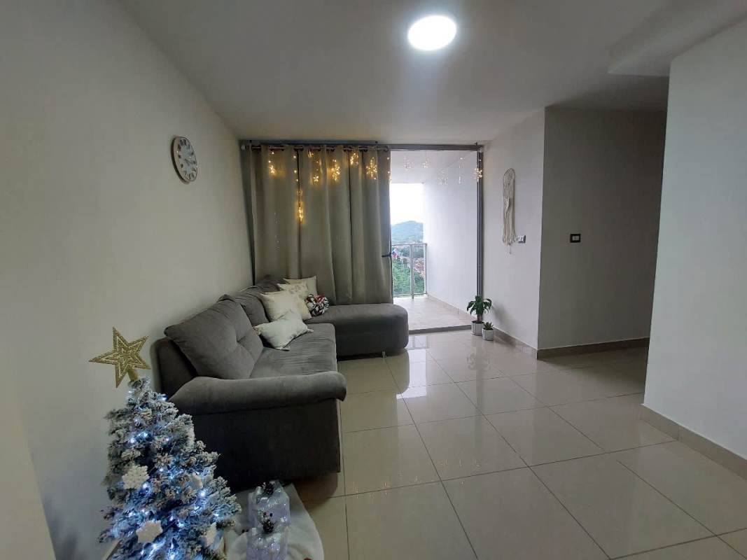 Modern living room with large mirror, gray sofa, minimalist decor at PH Rokas Panama