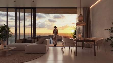 Modern living dining room with floor-to-ceiling windows and sunset balcony ocean views in Playa Bonita