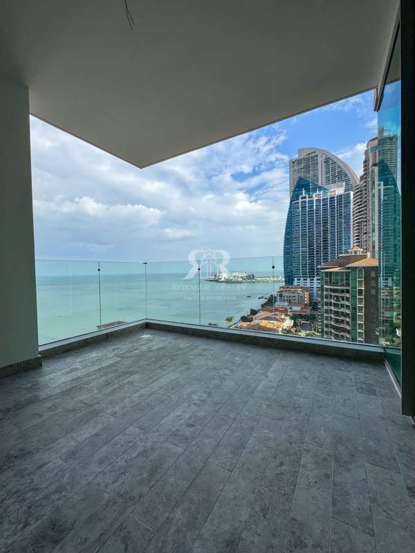 Spacious balcony with glass railing and panoramic ocean views at Pacific Point Tower Panama
