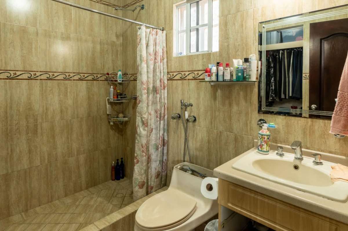 Bathroom with beige tiles walk-in shower vanity mirror Bosque de Cibeles Panama City