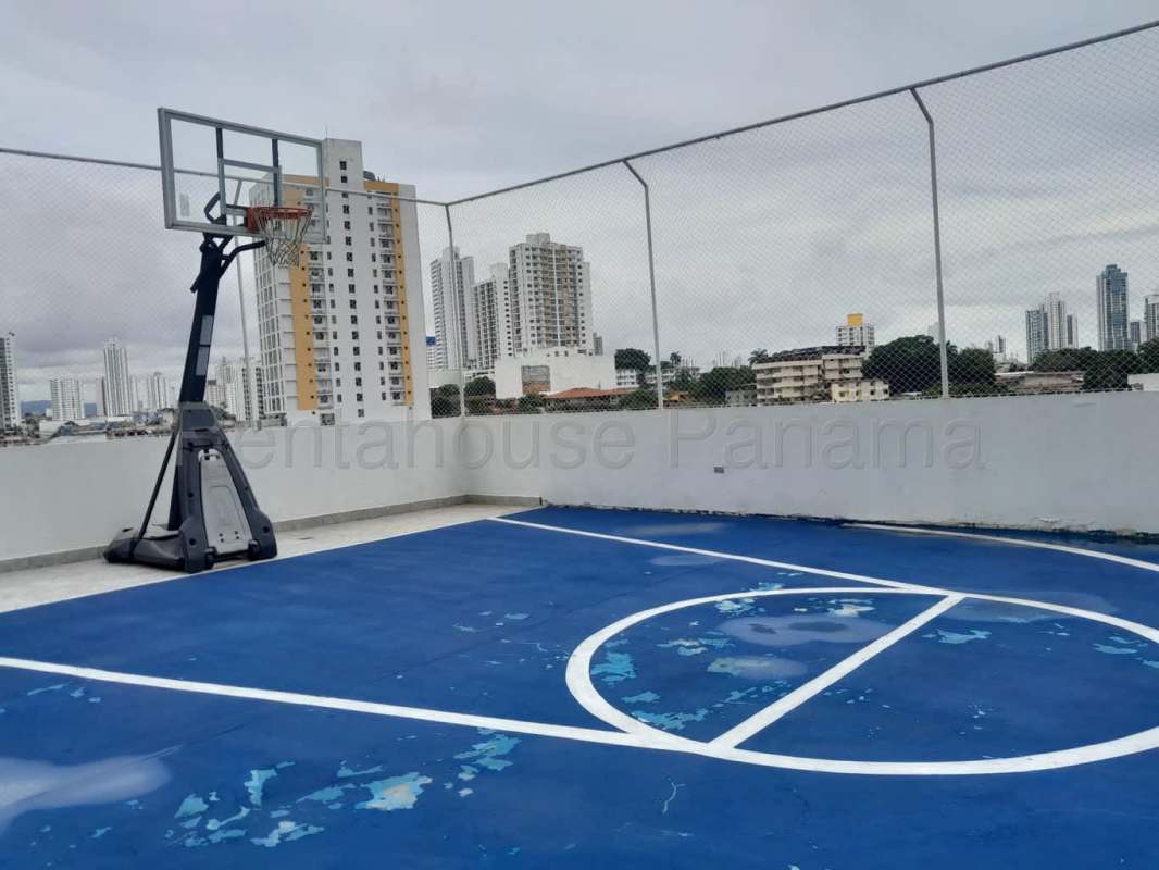 Rooftop fenced basketball court overlooking city skyline at Metropolitan Park