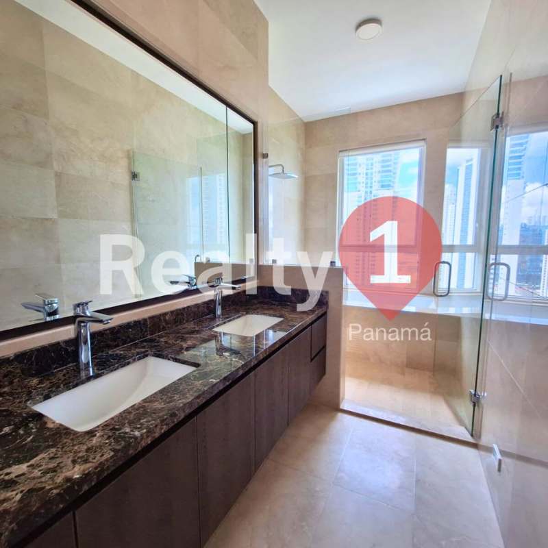 Bright spacious living room with large floor-to-ceiling windows and marble flooring at PH Aria luxury condo Costa del Este