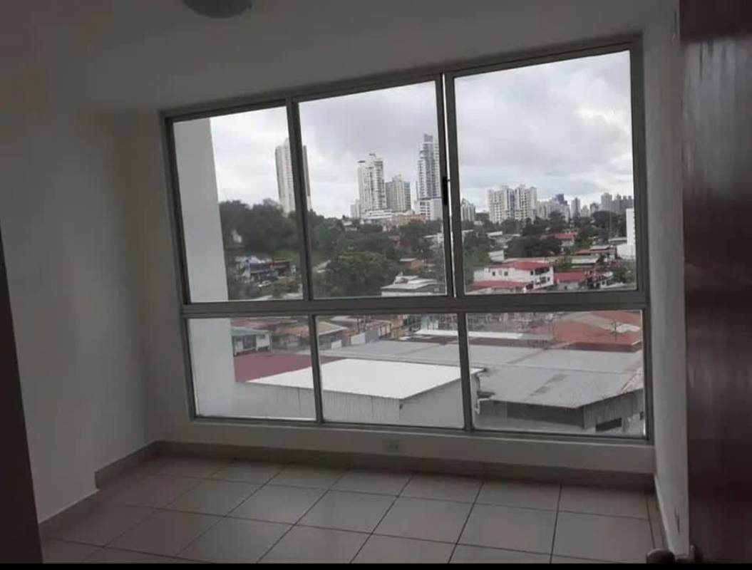 Empty room with big window showing city view tiled floors Central Park Panama City