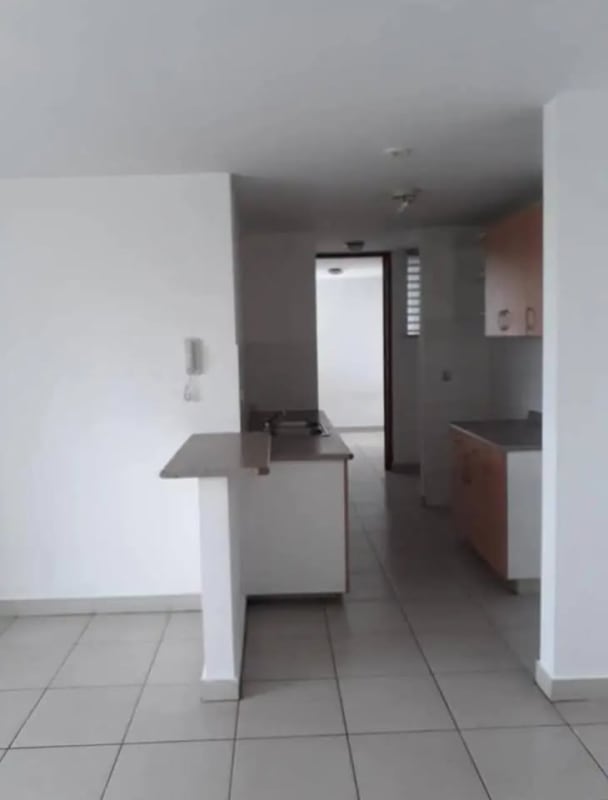 Modern white kitchen with breakfast counter, tile floor at Central Park near 12 Octubre Metro Panama City