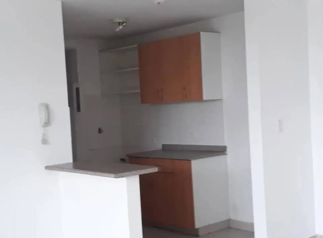 Modern kitchen with granite countertops, wood cabinets at PH Central Park Panama City rental