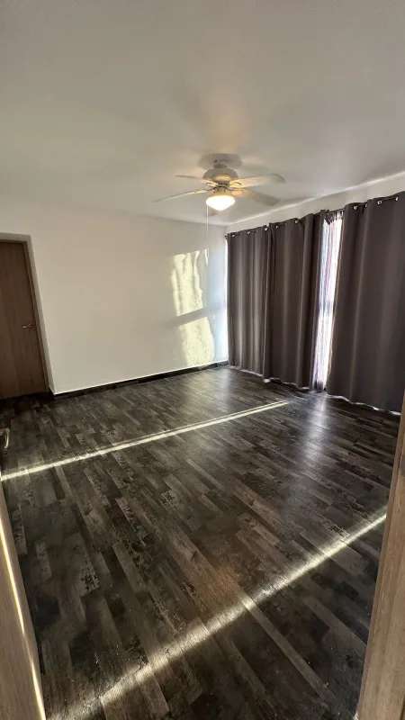 Empty bedroom with large windows, split AC, fan and closet in PH Moon Tower San Francisco Panama