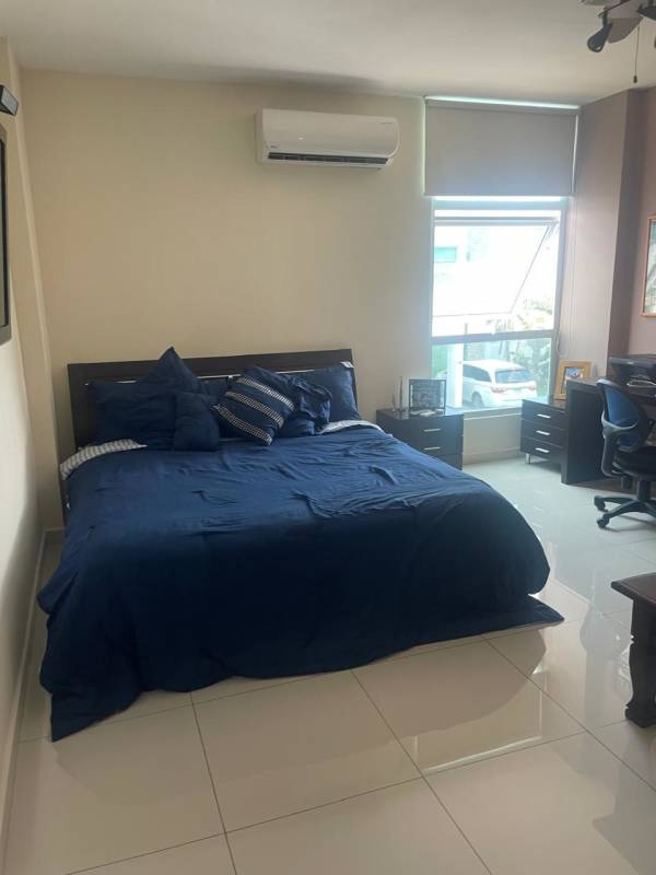 Cute children's bedroom with pink wall accents, window blinds in Panama house