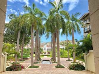 Landscaped garden courtyard with palm trees and reflecting pool at Buenaventura Resort