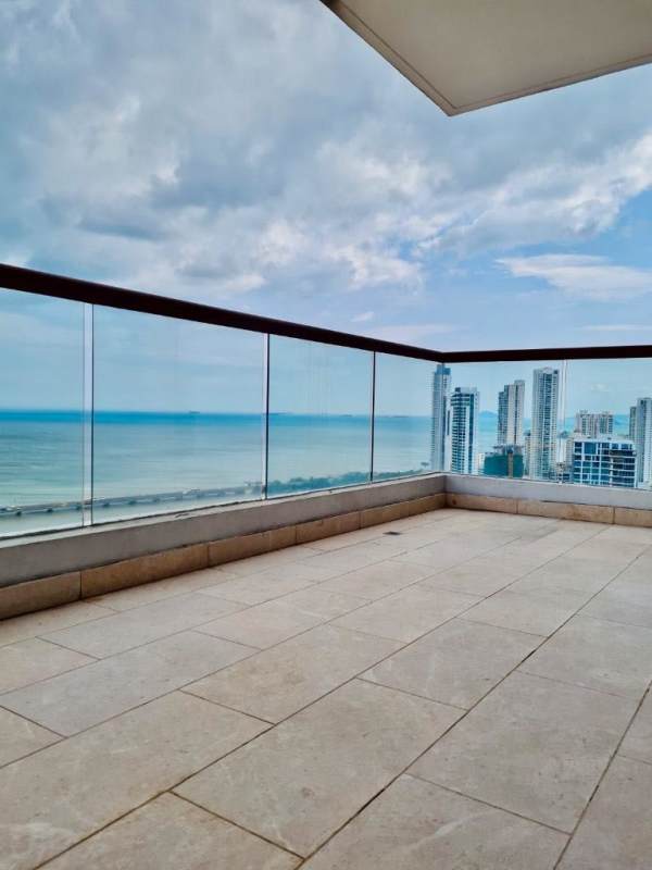 Large balcony with glass railing overlooking Pacific Ocean and skyline PH Dal Mare Panama City