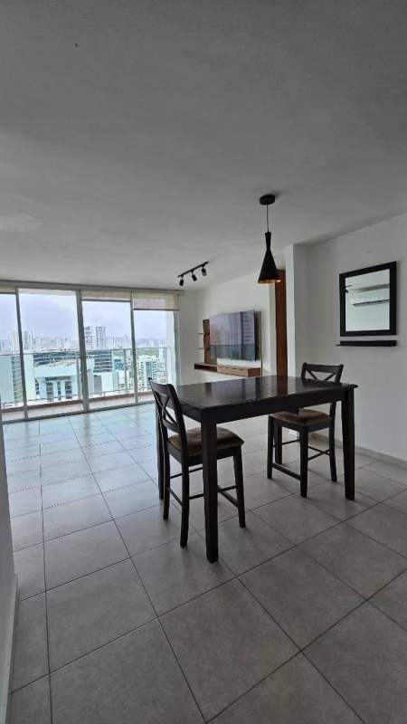 Colorful playground set on artificial grass beside tall residential tower in PH Terramar Panama City