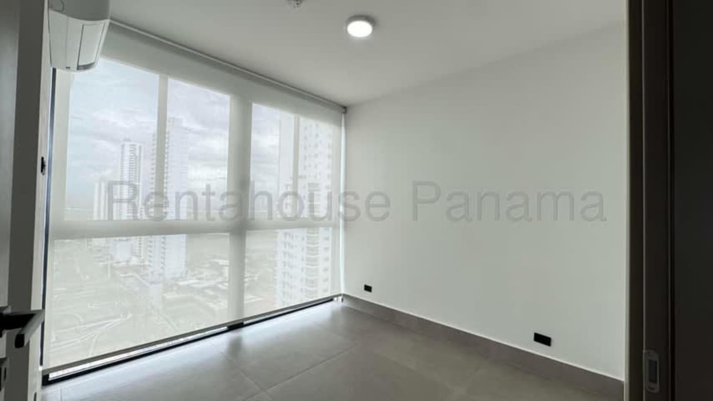 Galley kitchen with black countertops and beige cabinetry in PH Victory Wellness Panama