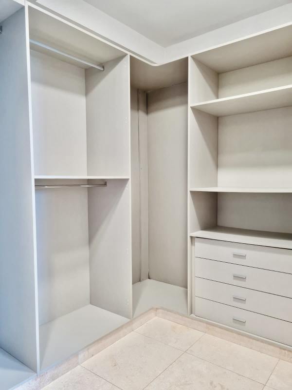 Spacious bedroom with floor-to-ceiling windows overlooking city and sea at PH Dal Mare Panama