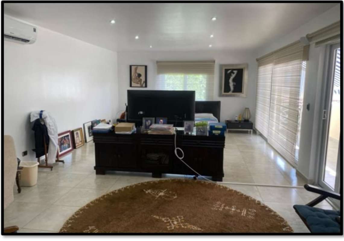 Large bedroom with TV console, windows, tile floor and AC in Clayton Panama luxury house