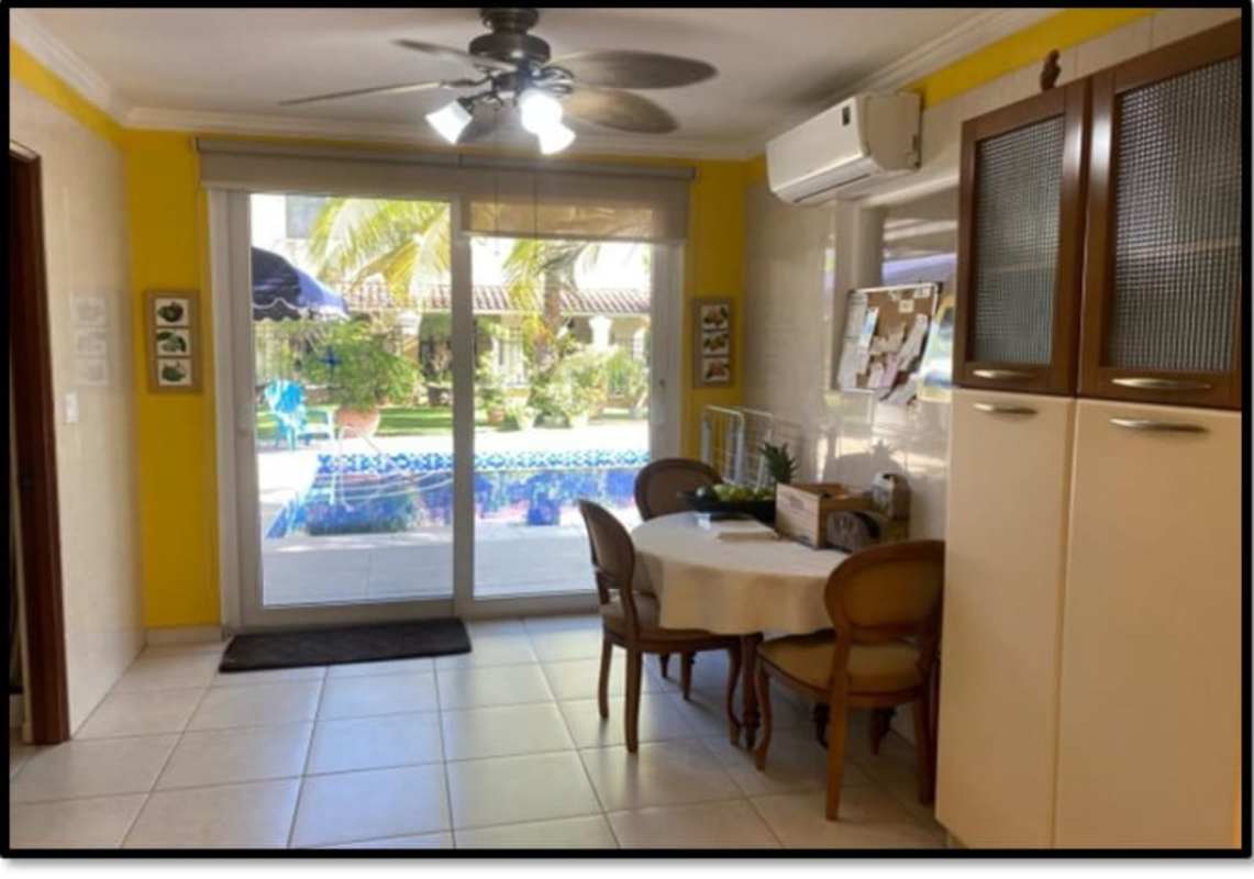 Covered parking with brick driveway and mature landscaping in Clayton luxury home