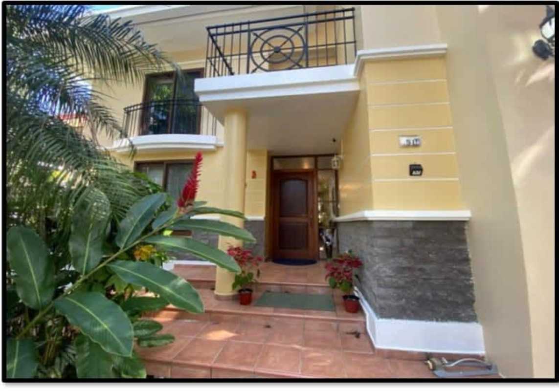 Spacious foyer with tiled stairs, artwork and pendant lighting in luxury Clayton house