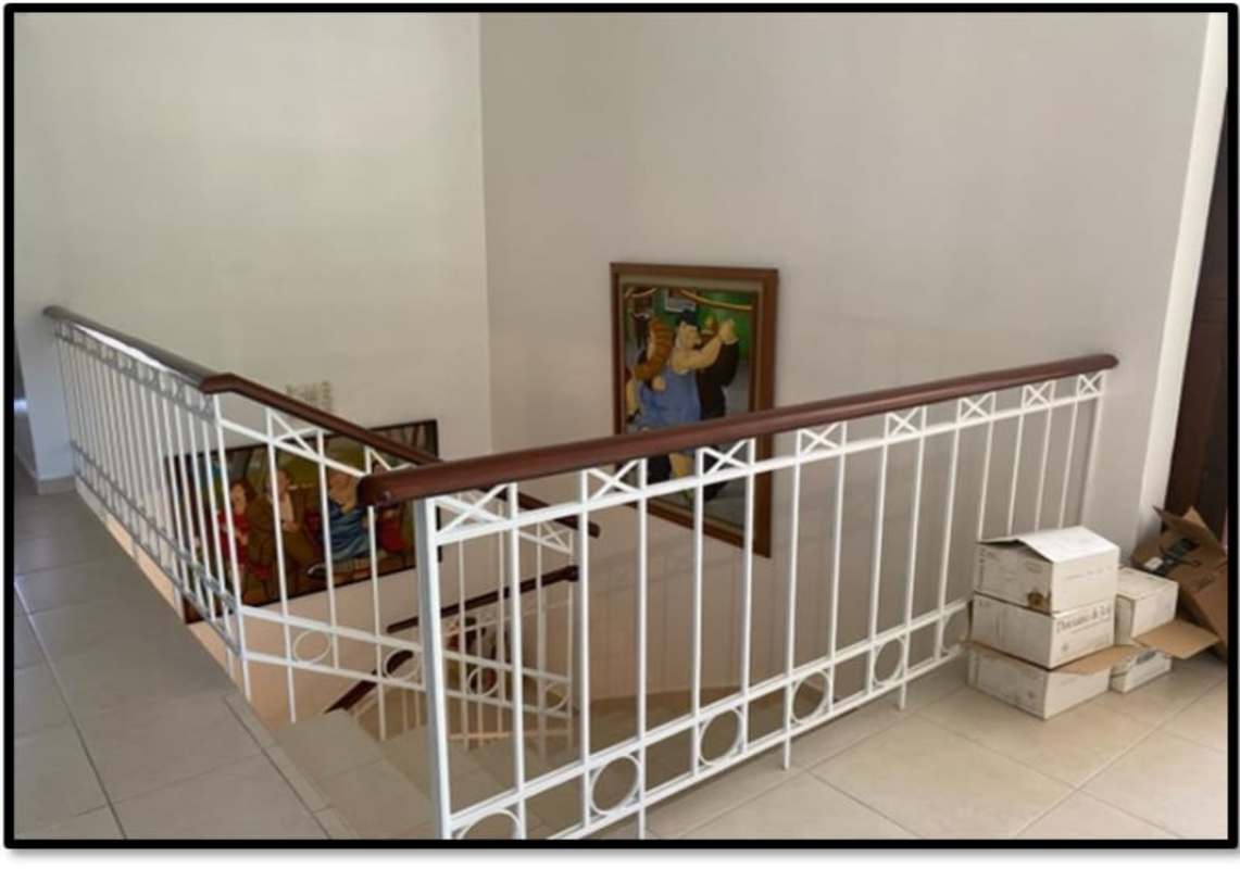 Spacious hallway with built-in bookshelf and staircase in Clayton Panama luxury house