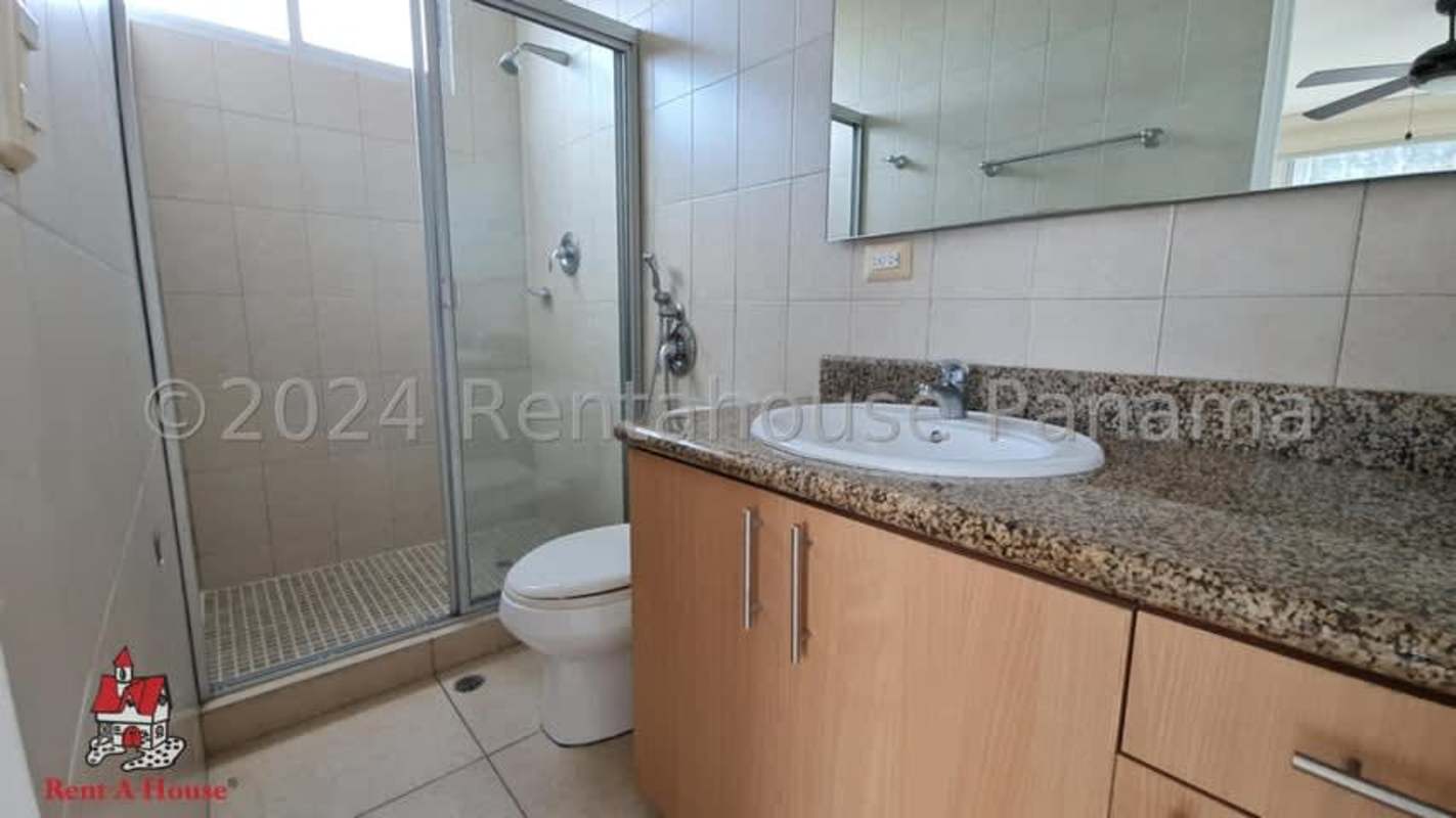 Modern bathroom with granite countertop vanity, glass-enclosed shower PH Sol del Este Costa del Este Panama