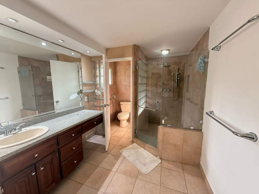 Contemporary bathroom with glass shower and double sink vanity in Altos de Balboa Panama