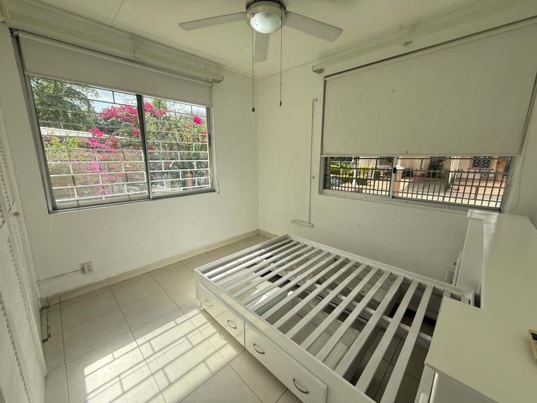 Bedroom with large windows, ceiling fan, bright interior in Ancón Panama City