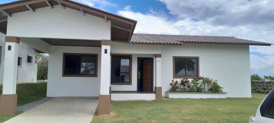 Single-story house with covered carport landscaped yard Isabella Gardens in Alto Boquete Panama