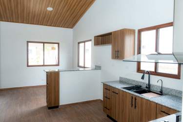 Contemporary open kitchen granite countertops wood cabinets windows Isabella Gardens Boquete Panama