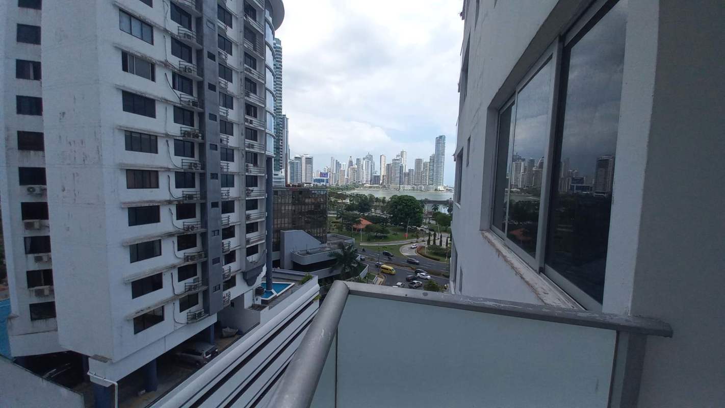 Bedroom in PH Parque Balboa with large windows, ocean view, ceiling fan, wooden floor