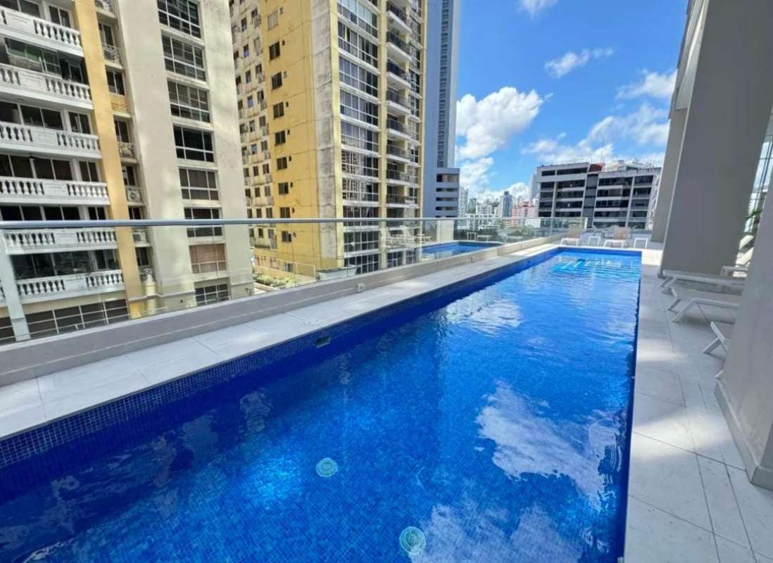 Rooftop terrace lounge area with bar counter, panoramic city view at PH Urbana Obarrio Panama City