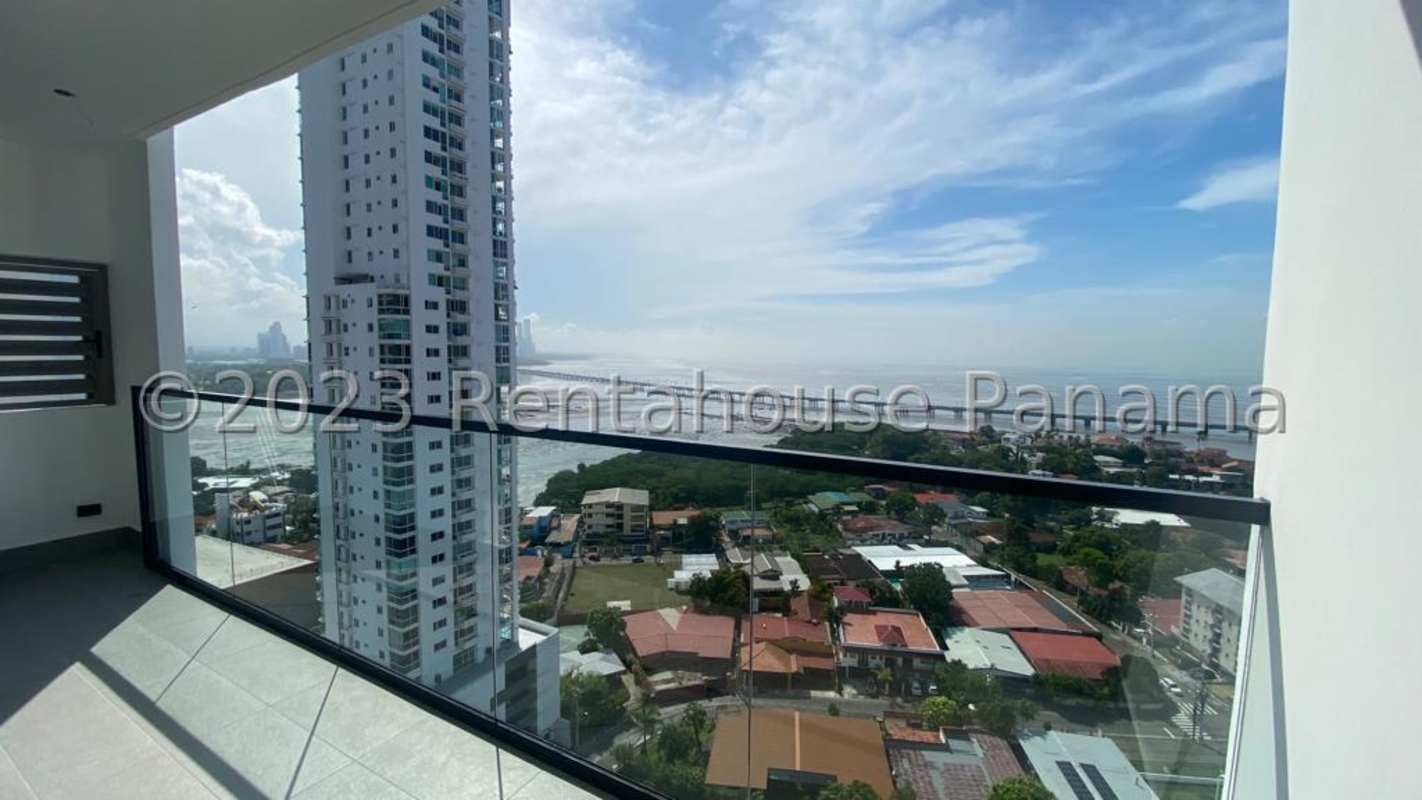 High-rise balcony with glass railing and ocean/city skyline views in PH Victory Wellness Coco del Mar