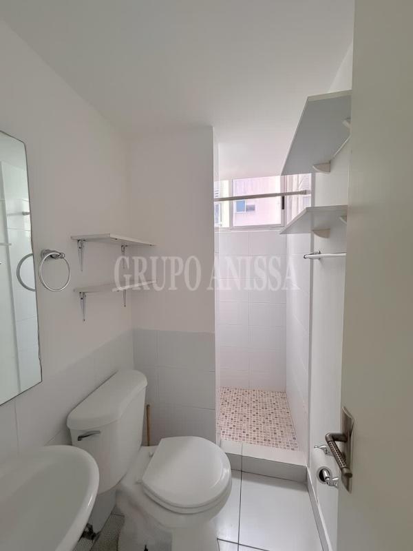 Modern bathroom walk-in shower white tiles PH Balboa Gardens Rio Abajo Panama
