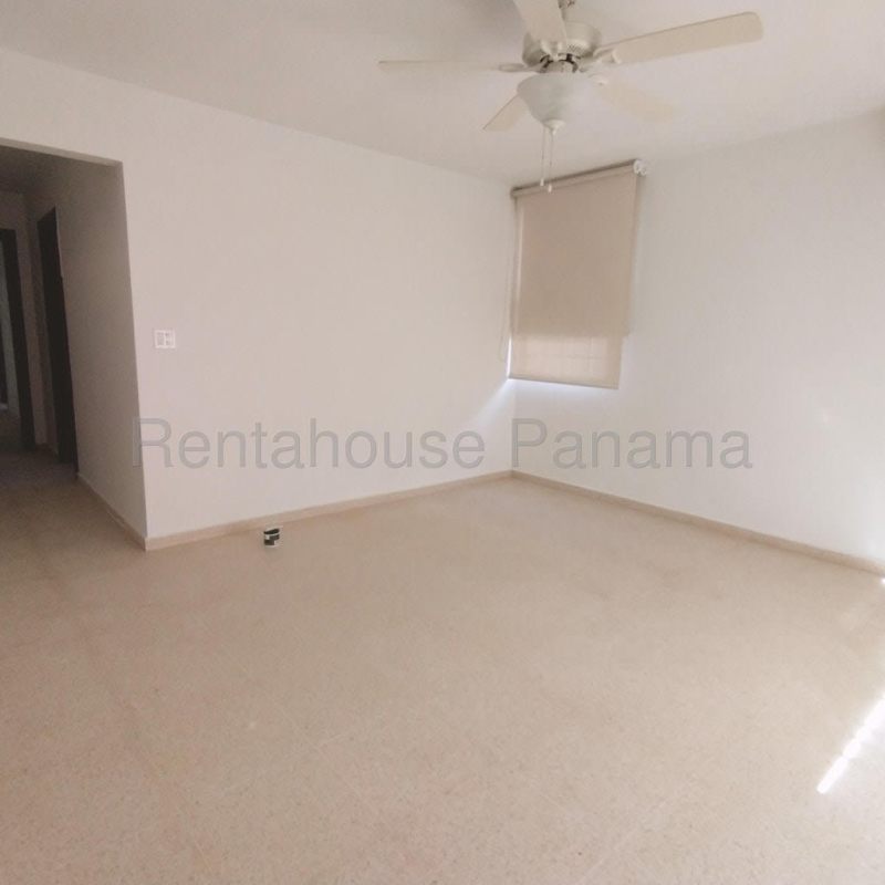 Bedroom with large window, built-in closet and ceiling fan in Costa del Este house Panama