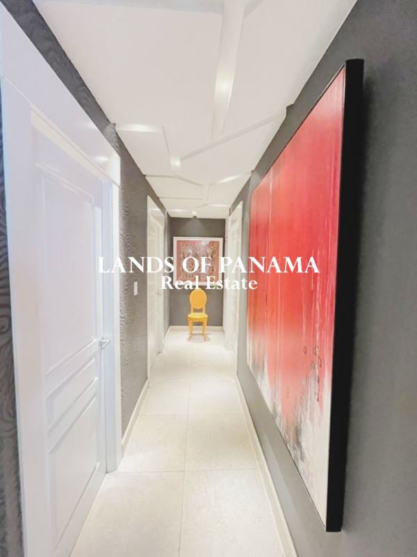 Gourmet kitchen with wood cabinetry and granite counters in PH Sol Marina Marbella Panama