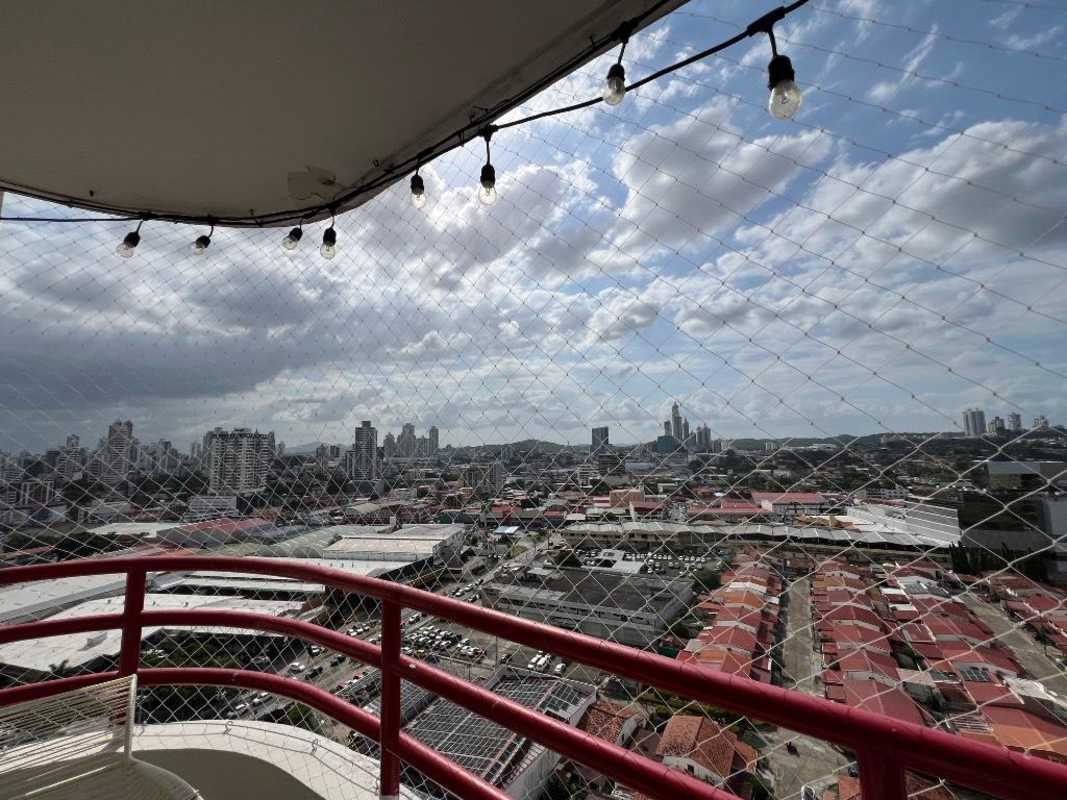 Balcony with safety net, hammock, red railing and panoramic city view at PH El Marquez for rent Panama City