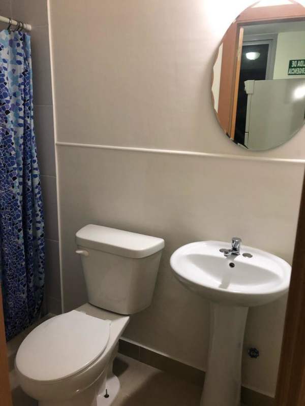 Modern bathroom with walk-in shower, vanity with granite countertop at PH Rokas in Panama City