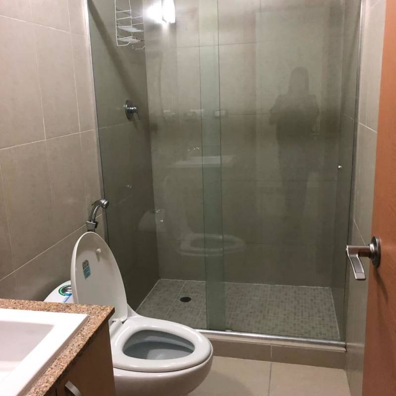 Outdoor swimming pool surrounded by deck and high-rise towers at PH Rokas Condado del Rey Panama City