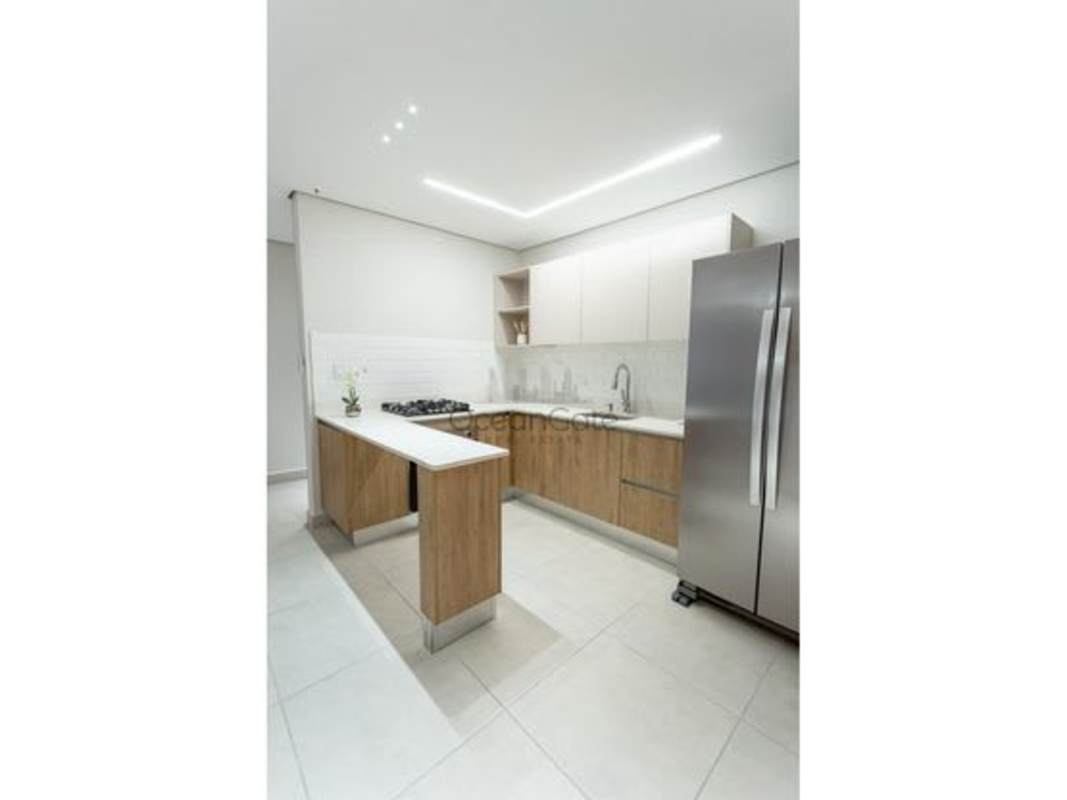 Open plan living room and kitchen area neutral design PH Mi Condado Condado del Rey Panama